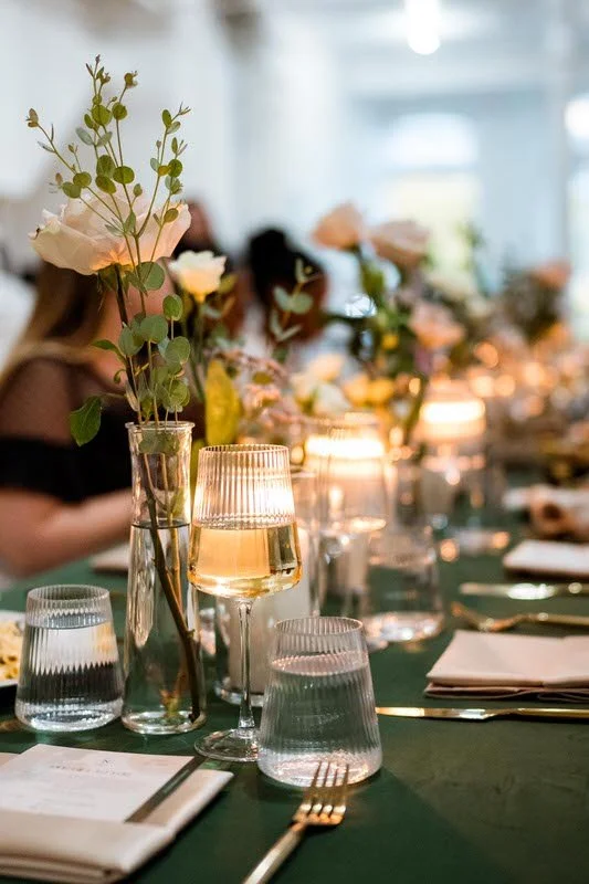 Intimate wedding reception dinner at The Harlow Exchange in Winnipeg — green linen tables and candlelight