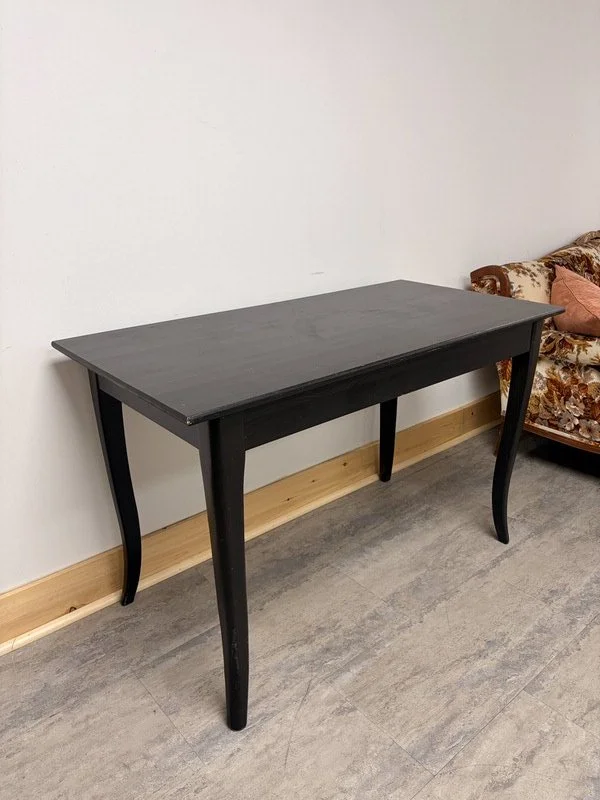 Black wooden table included with every event booking at The Harlow Exchange in Winnipeg's Exchange District