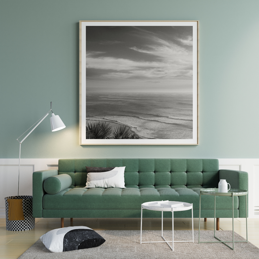 black and white framed photo with soft waves and high clouds framed mockup.png