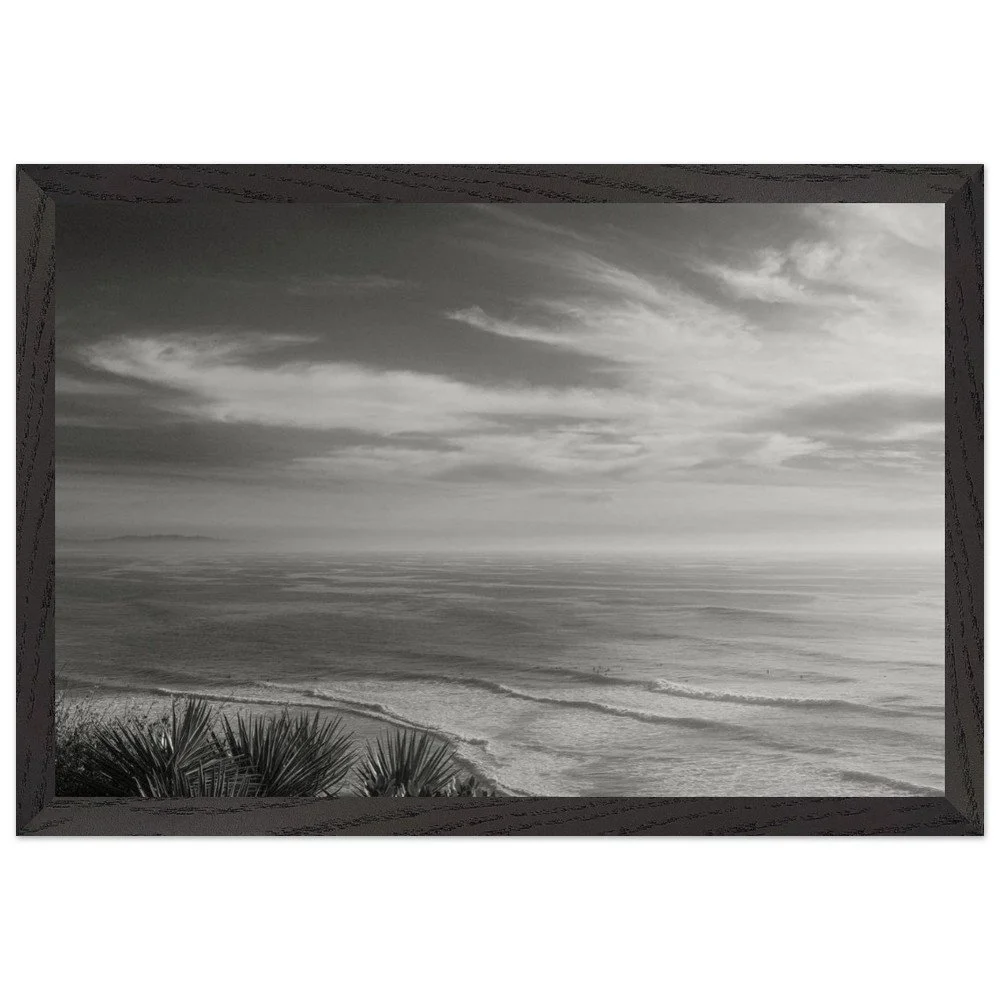 black and white framed photo with soft waves and high clouds framed mockup.png