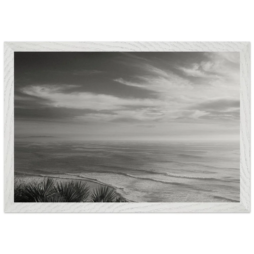 black and white framed photo with soft waves and high clouds framed mockup.png