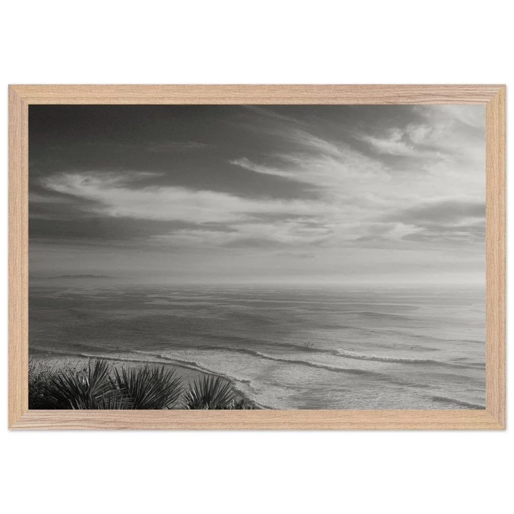 black and white framed photo with soft waves and high clouds framed mockup.png