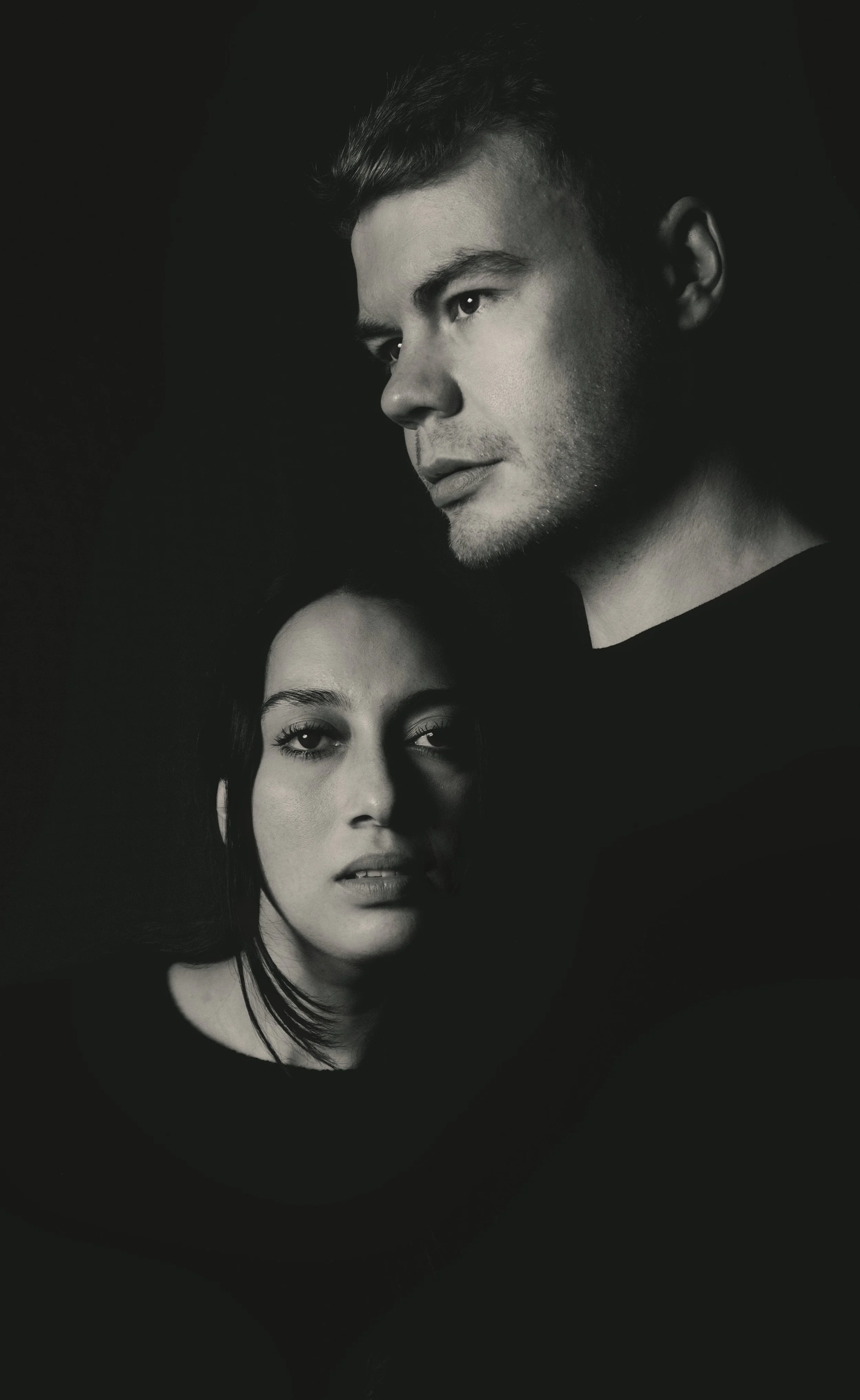 black and white portrait of a couple, she is looking at the camera he is looking to the side