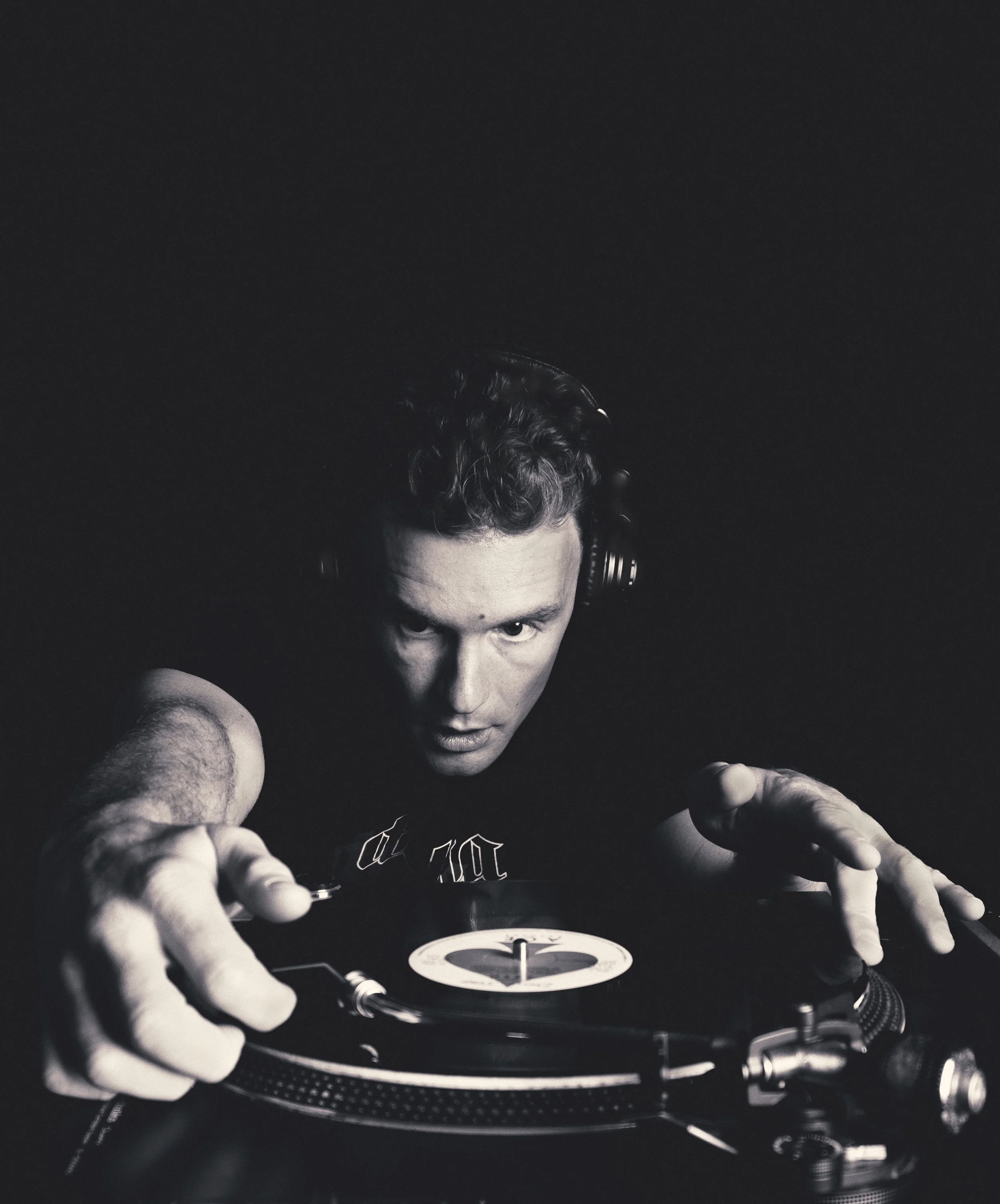 Black and White portrait of DJ playing a record