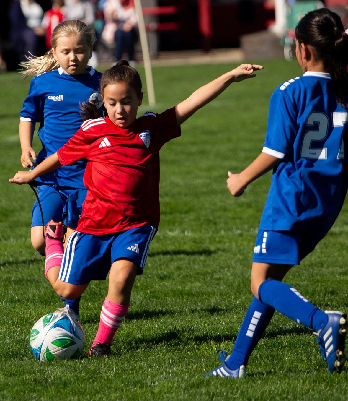 Girl shielding the ball from defenders — sports photography in Long Island