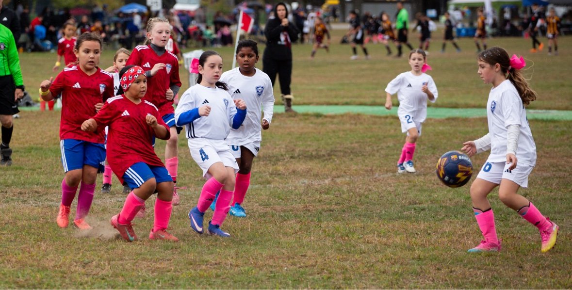 Wide view of a youth soccer game in action — sports photography in Long Island