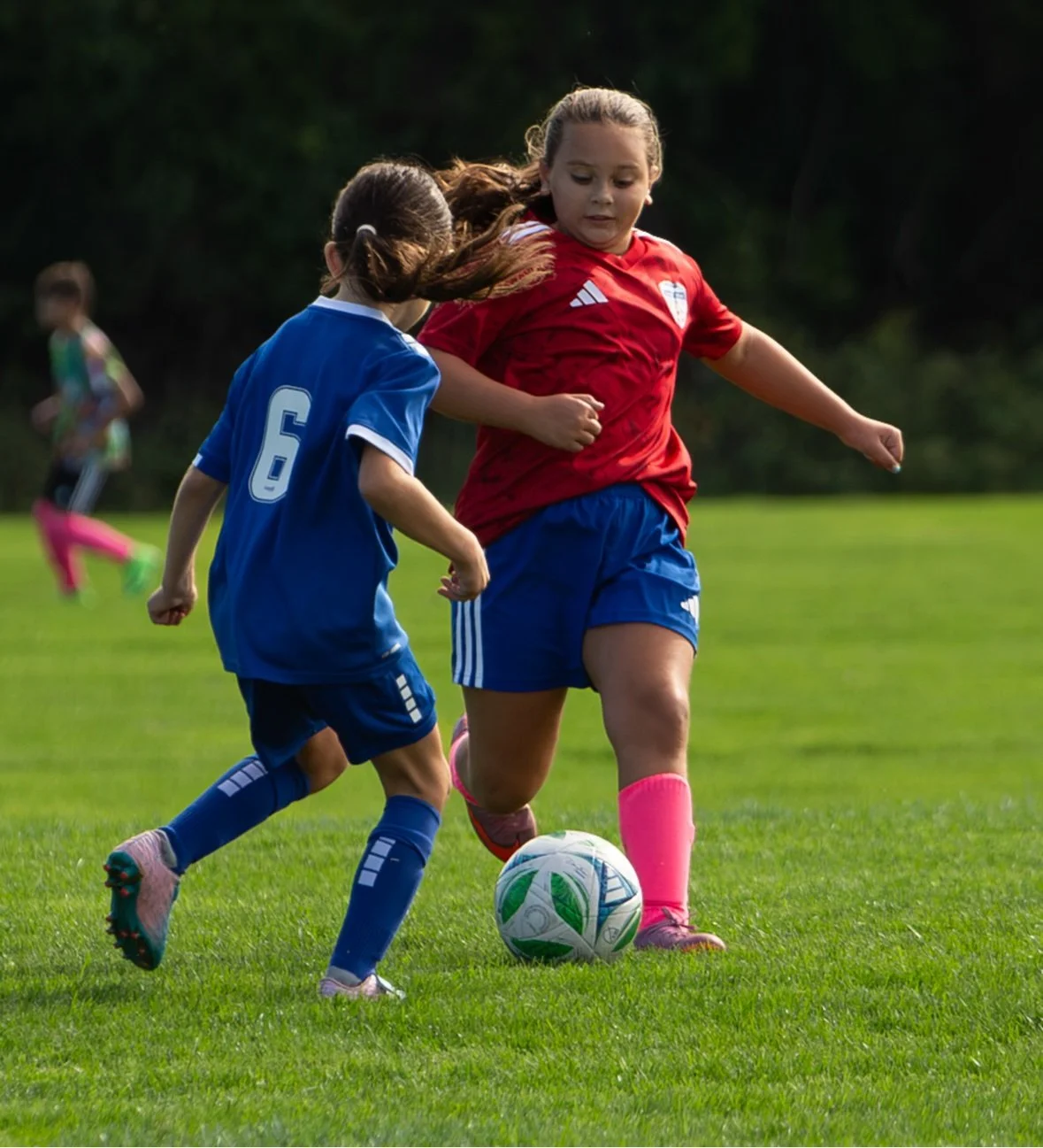Two girls contesting the ball — sports photography in Long Island