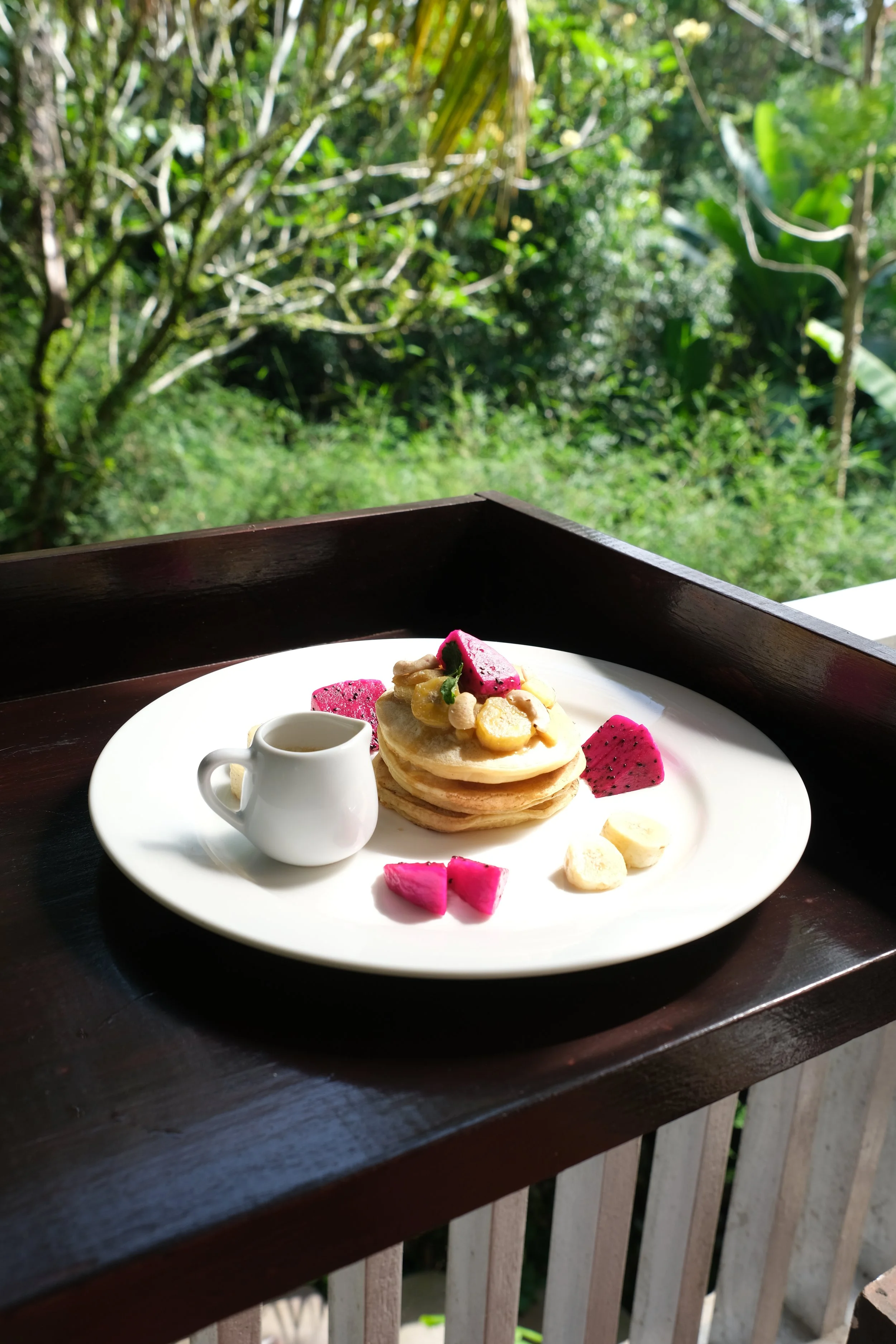 Unity Cafe Pancakes topped with bananas, dragon fruit, and other fruits.