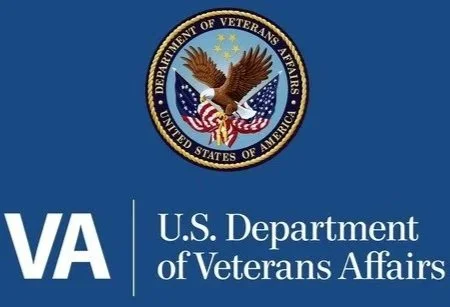 U.S. Department of Veterans Affairs seal with an eagle, American flags, and stars, on a blue background.