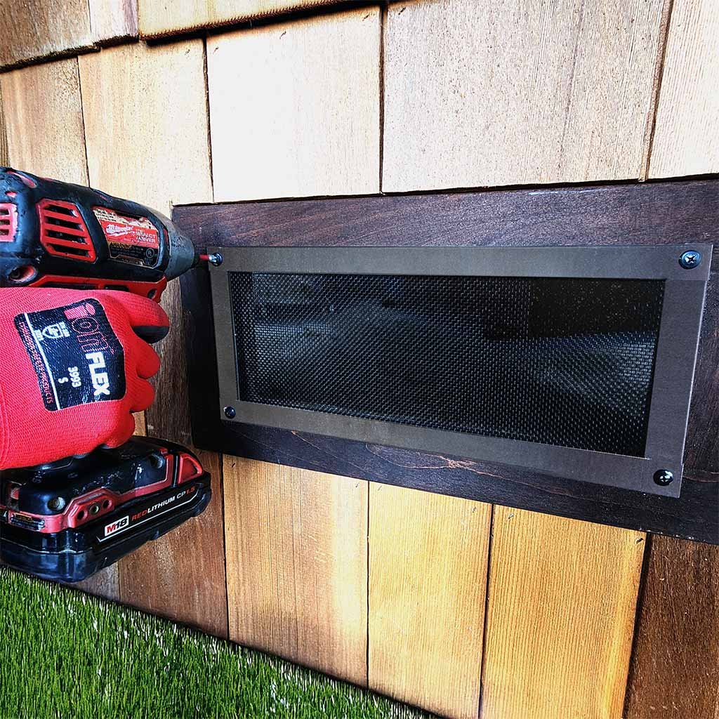 Ember-resistant mesh vent being installed on a home exterior for wildfire home hardening