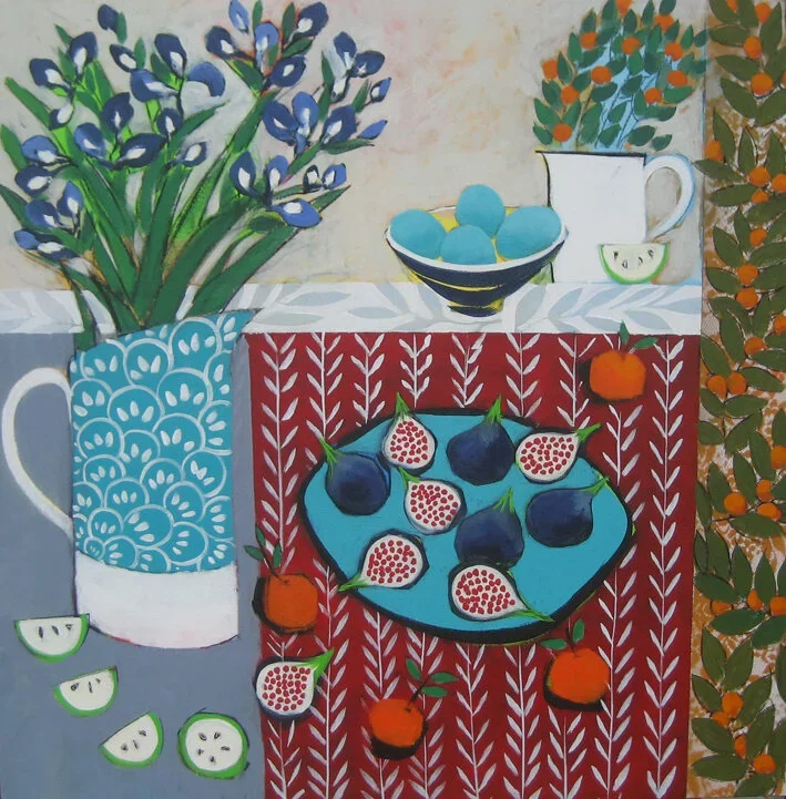A colorful still life painting of a table setup with a vase of blue flowers, a bowl of blue eggs, a white pitcher, a small white bowl, a plate of figs, and oranges; decorated with patterned tablecloths and surrounding foliage.