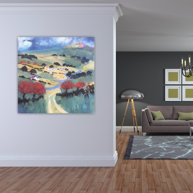 Interior living room with colorful landscape painting on white wall, gray walls in background, modern lamp, purple sofa with green pillows, and chandelier.