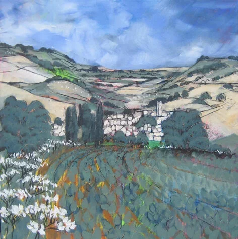 A vibrant landscape painting of rolling hills, a village with white buildings, trees, and a field with daisies under a partly cloudy sky.