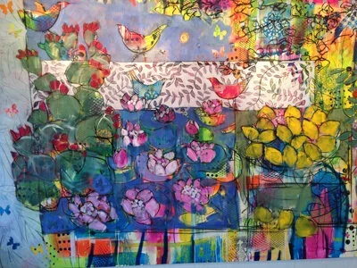 Colorful abstract collage featuring bird and floral motifs, including pink lilies, yellow flowers, and green foliage, with a vibrant background of mixed colors and textures.