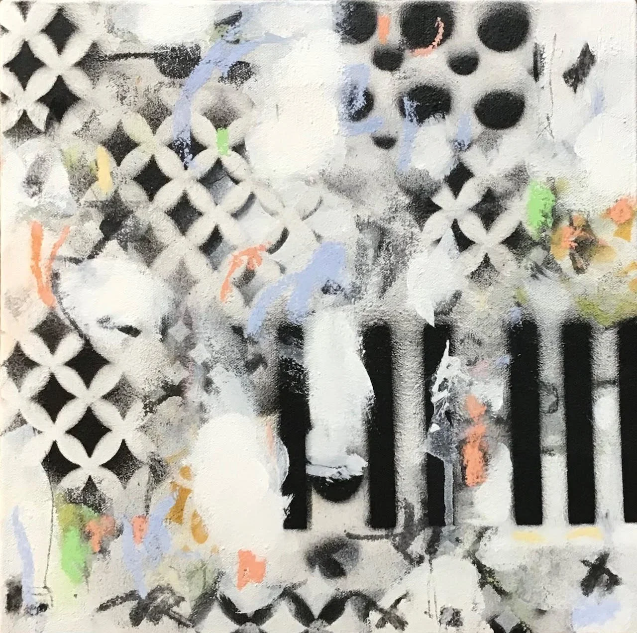 Abstract black and white graffiti art with colored accents on a wall, featuring geometric patterns, lines, and spray paint textures.