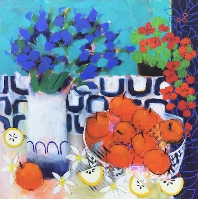 Colorful still life painting featuring a blue flower bouquet in a white vase, a bowl of oranges, lemon slices, red flowers, and white flowers, set against a vibrant patterned background.
