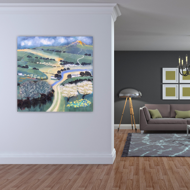 Living room with a light gray wall, a colorful landscape painting, a modern floor lamp, a gray couch with green pillows, a framed wall art, and a chandelier.