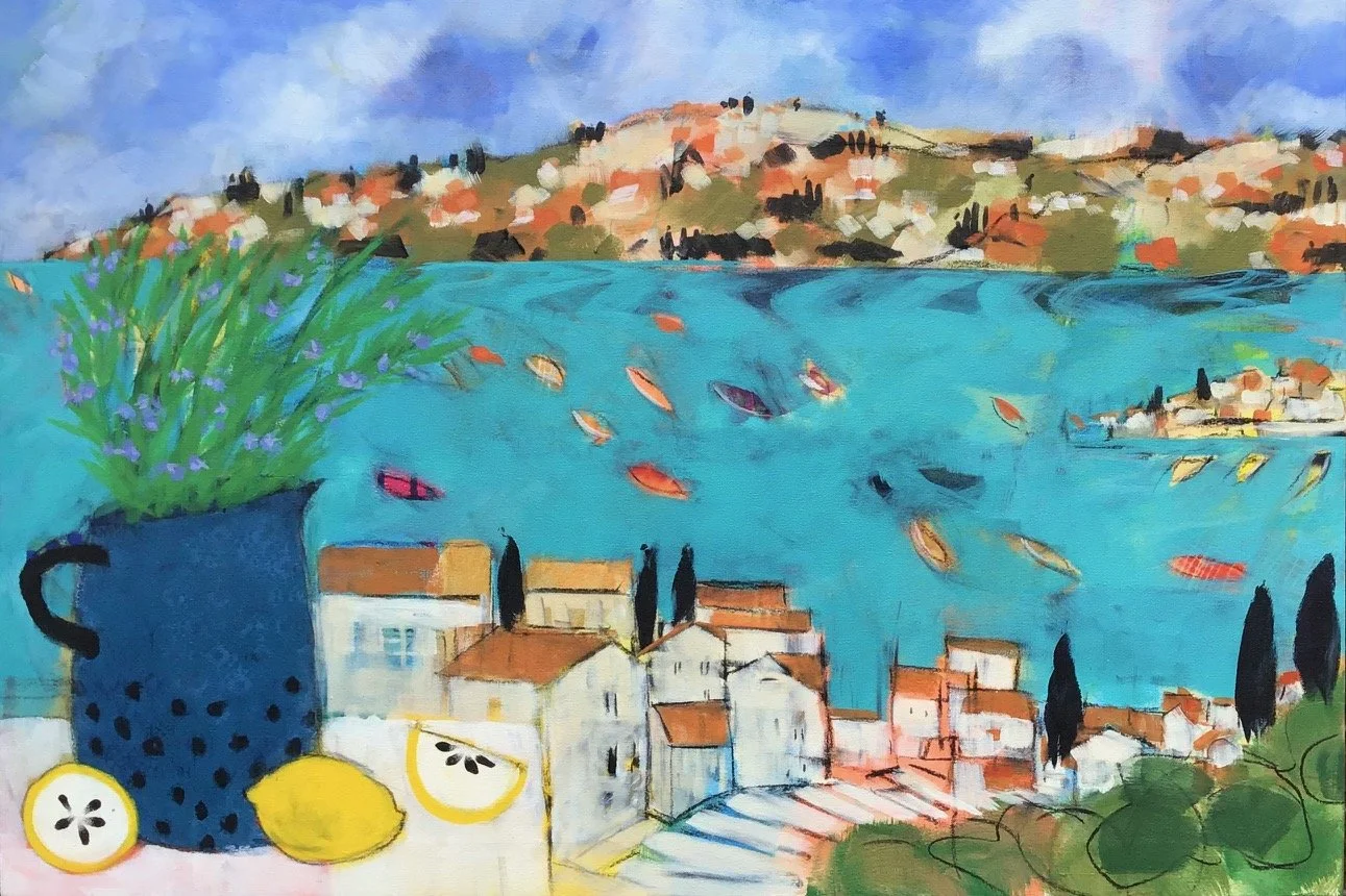 A colorful watercolor painting of a seaside town with houses along a hill and a body of water with boats. In the foreground, a blue watering can with purple flowers, lemons, and lemon slices.