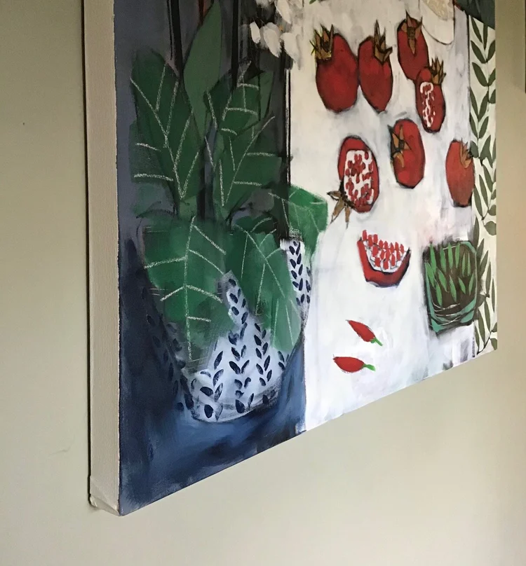 Painting of pomegranate fruits and a potted plant on a white tablecloth.