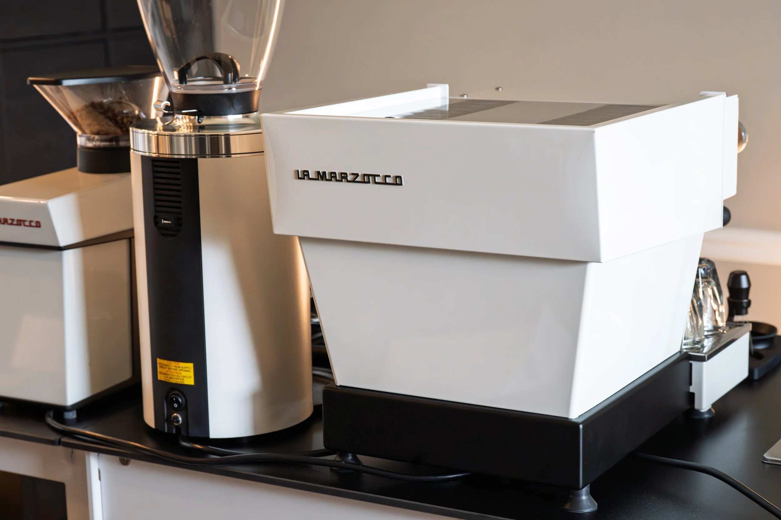A white La Marzocco Linea Mini R espresso machine, Mahlkönig E65T espresso grinder, and a La Marzocco Pico coffee grinder on a Simple Cart Systems coffee cart owned by Preamble Coffee cart catering, ready to serve guests with coffee catering.