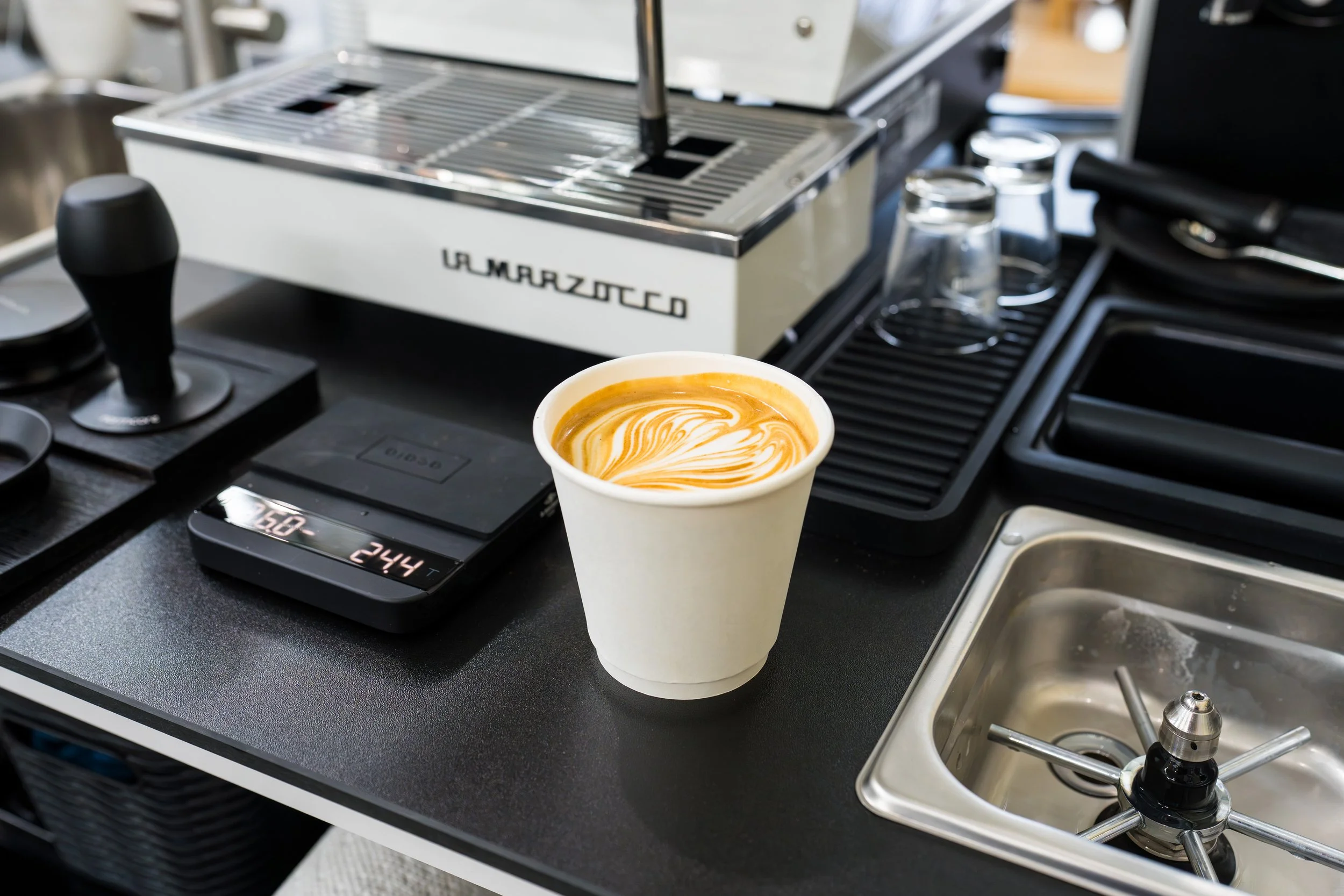 A flavored latte with latte art that was expertly crafted with skill by Preamble Coffee cart catering in Fort Wayne, Indiana using a La Marzocco Linea Mini R.