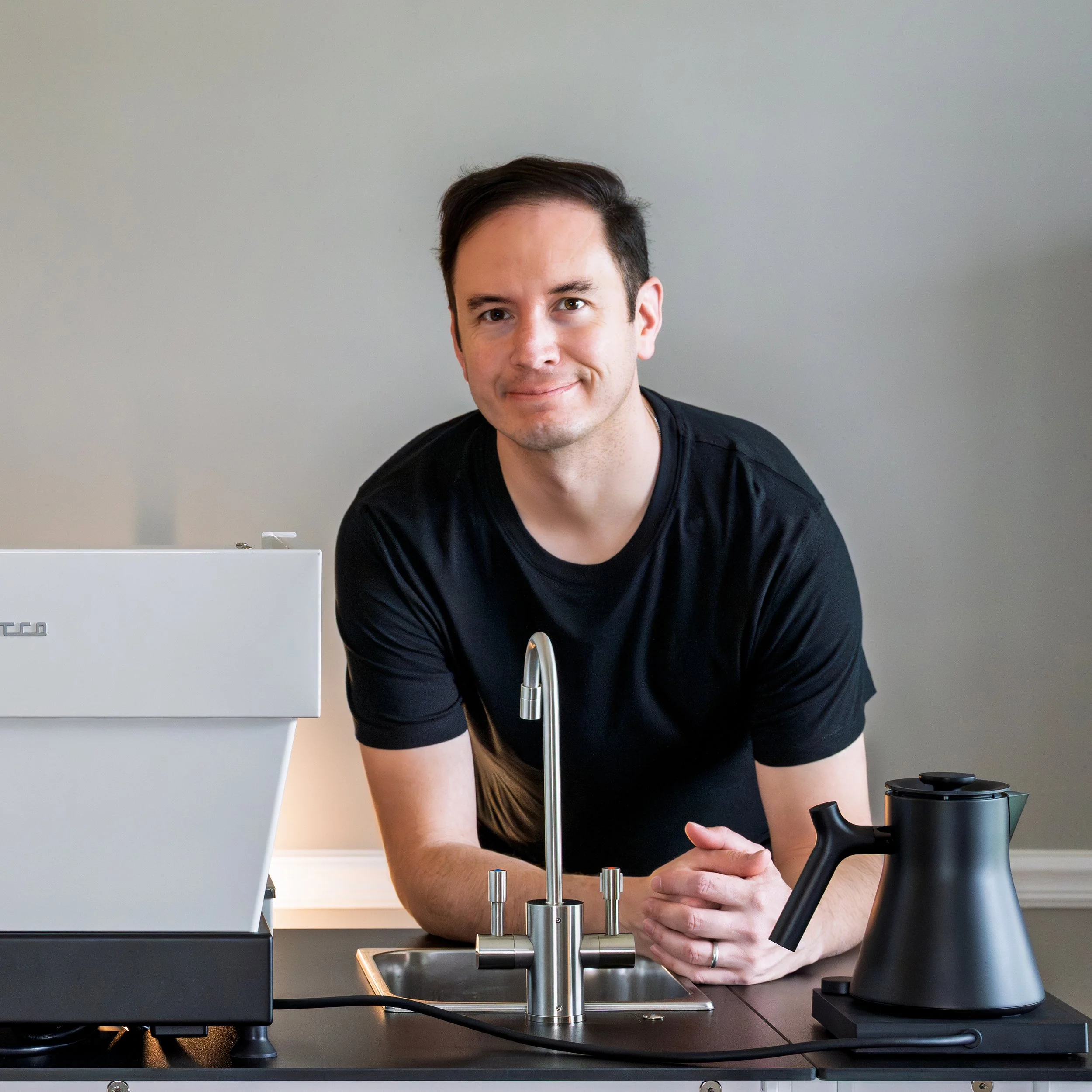 The owner of Preamble Coffee cart catering in Fort Wayne, Indiana leaning on his mobile espresso bar by Simple Cart Systems, ready to provide coffee catering for private events, weddings, bridal showers, baby showers, corporate meetings, and more.