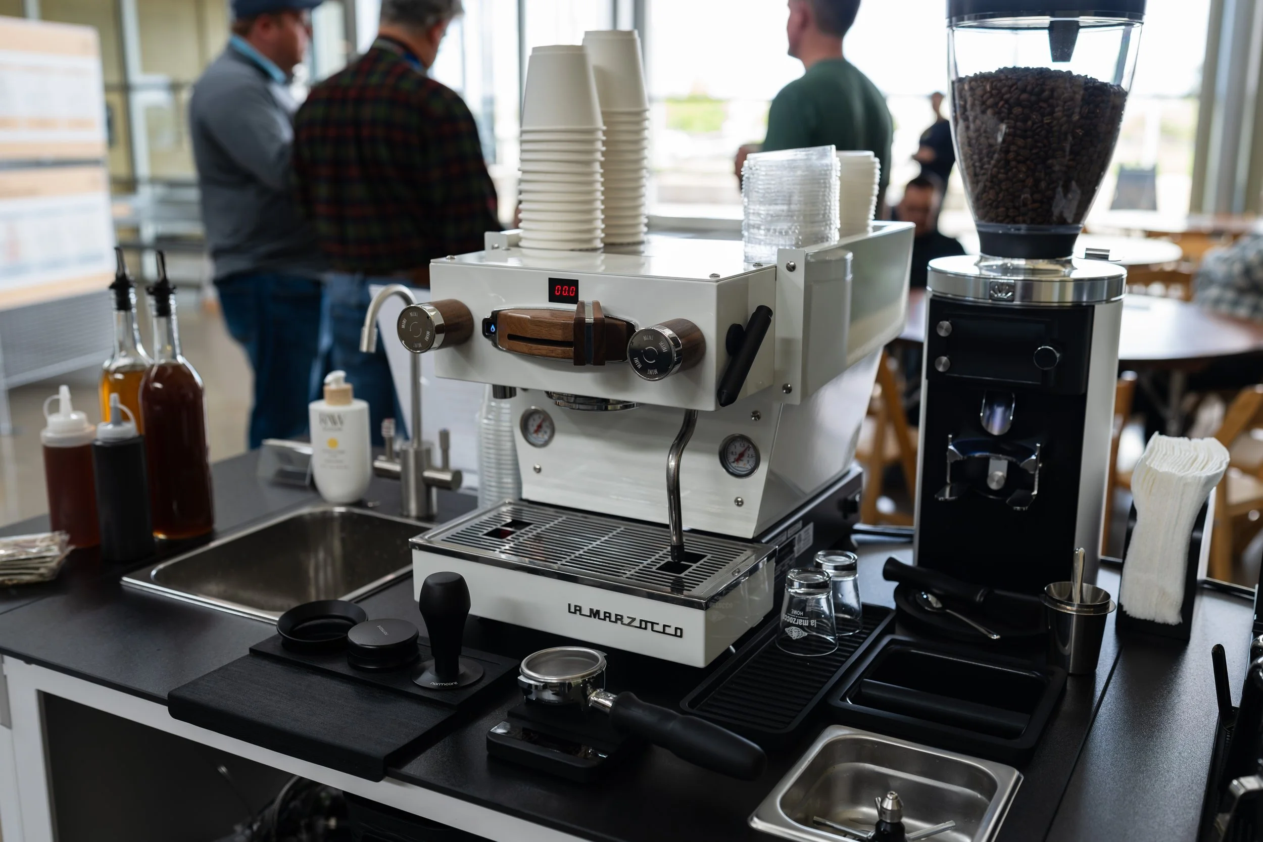 A corporate event being catered by Preamble Coffee cart catering in Fort Wayne, Indiana as guests talk to each other while enjoying the coffee prepared for them.