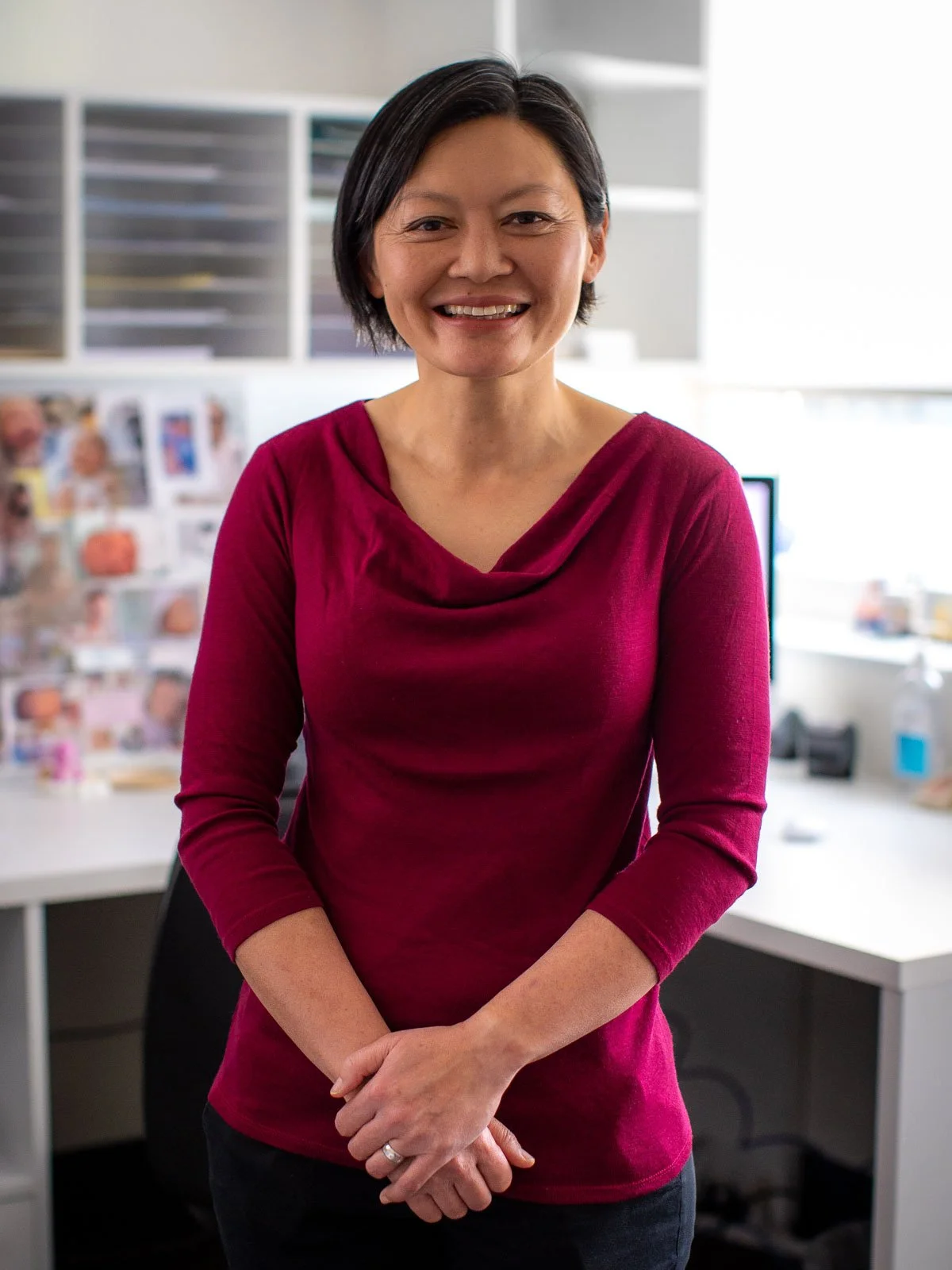 standing profile image of dr renee wong woman in red top