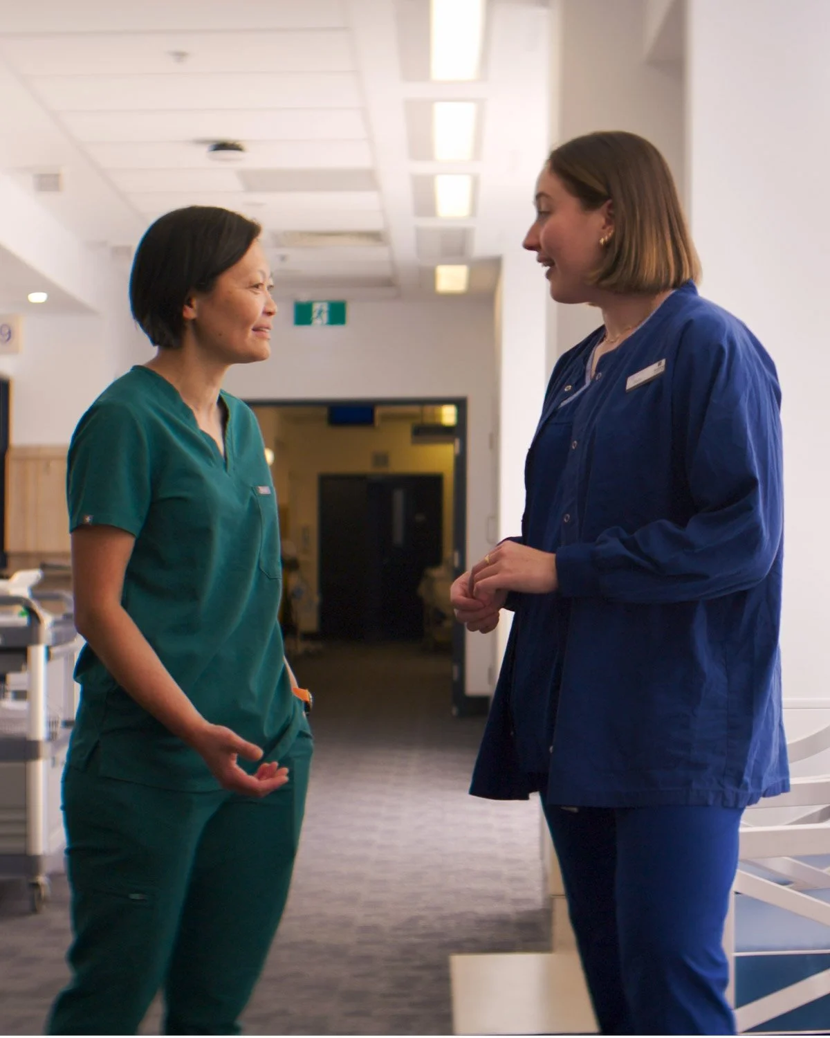 dr renee wong doctor standing with midwife chatting