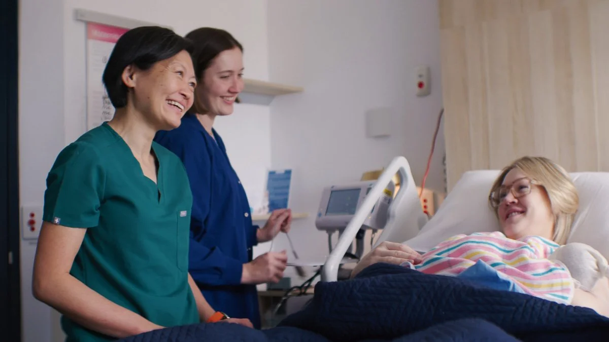 dr renee wong standing bedside talking to pregnant patient