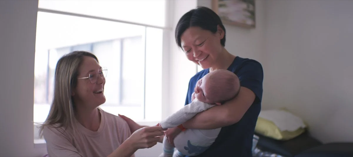 dr renee wong holding baby with patient