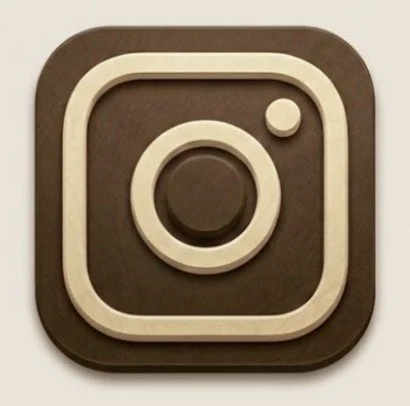 Wooden logo of Instagram app with a camera icon on a dark square background.