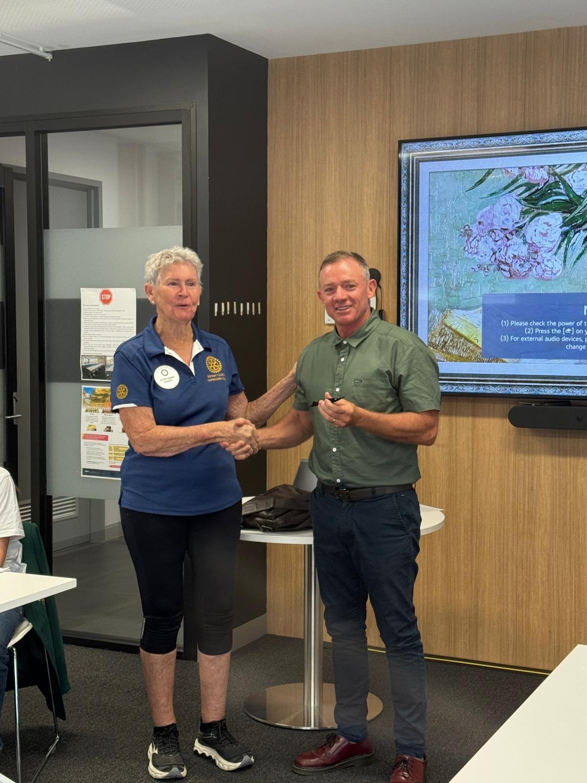 Rotary woman shaking hands with a male, 2025 Yeppoon mayor