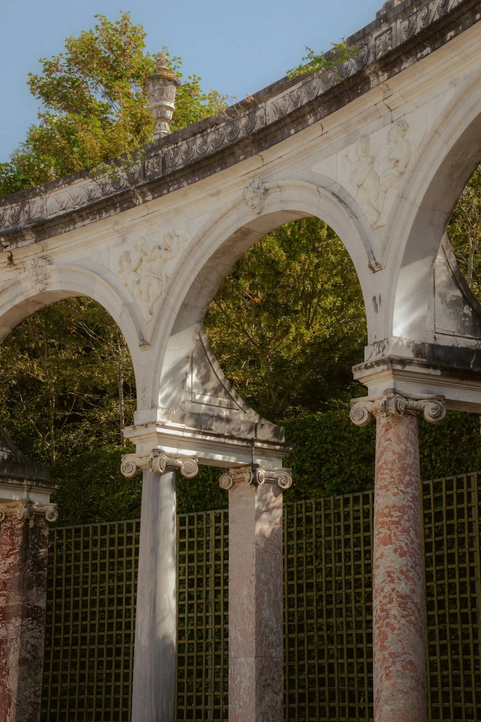 a marble archway with dappled sunlight