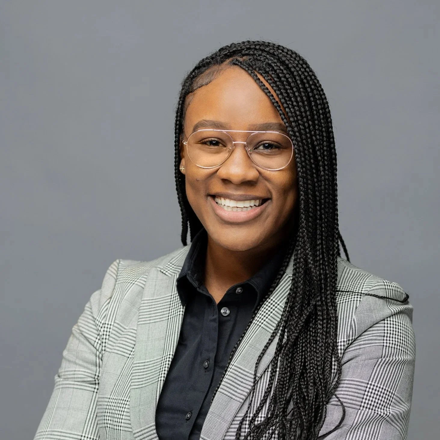 Portrait of Shamiea Green, a Chicago attorney, smiling against a plain gray background.