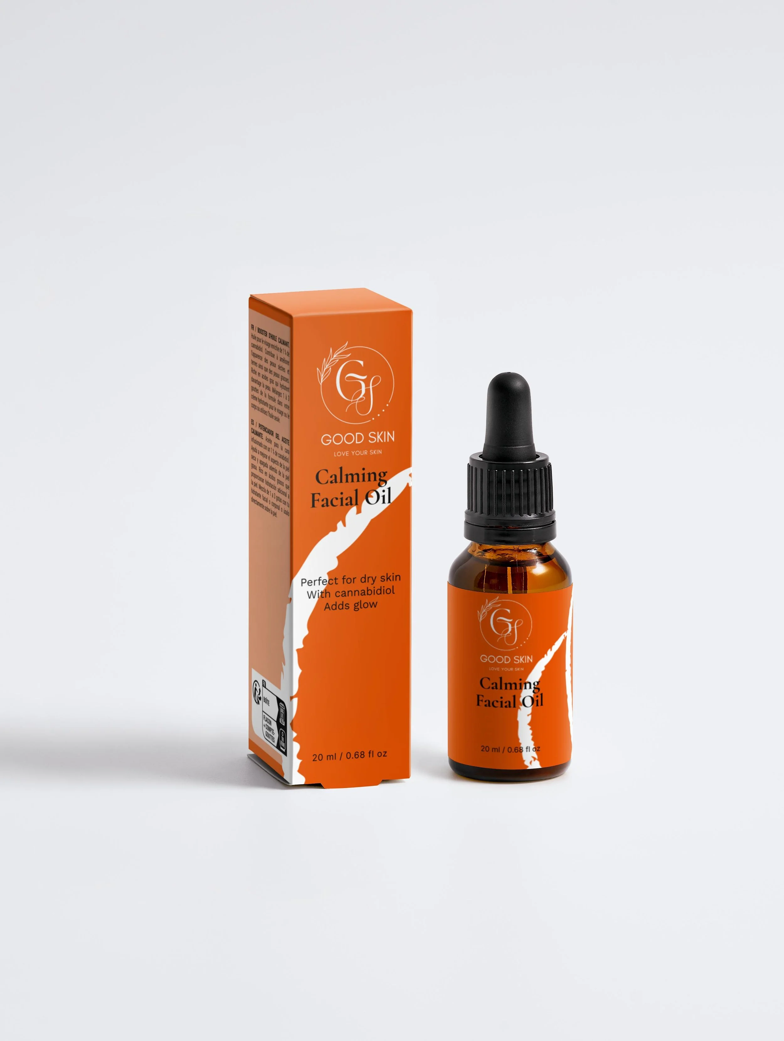 A bottle of Good Skin Calming Facial Oil next to its orange packaging box.