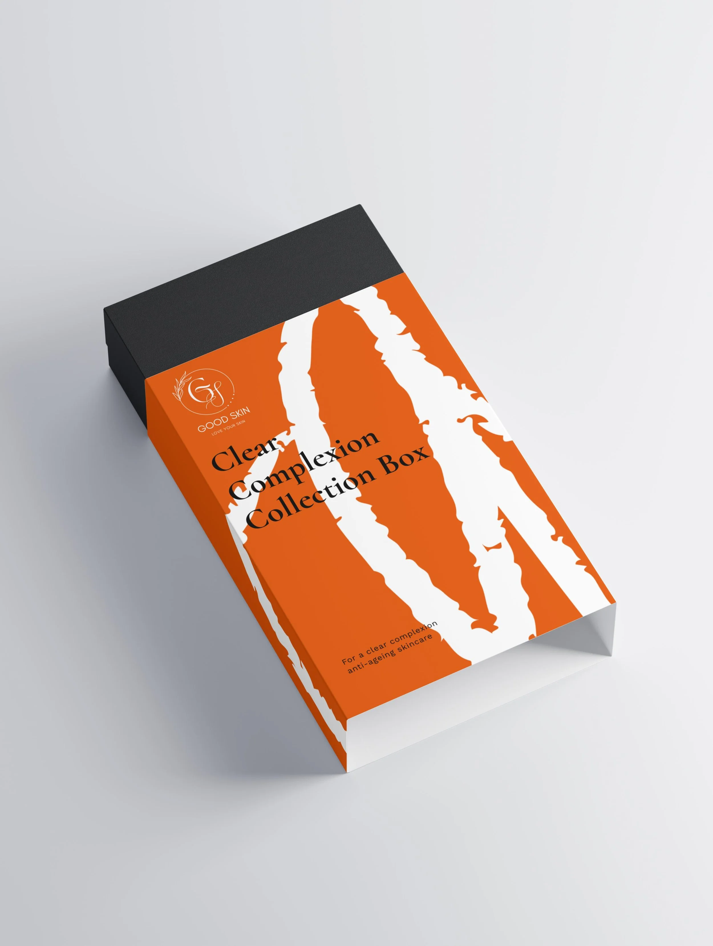 Packaging box labeled 'Clear Complexion Collection Box' with orange and white abstract design and black top, for skincare.