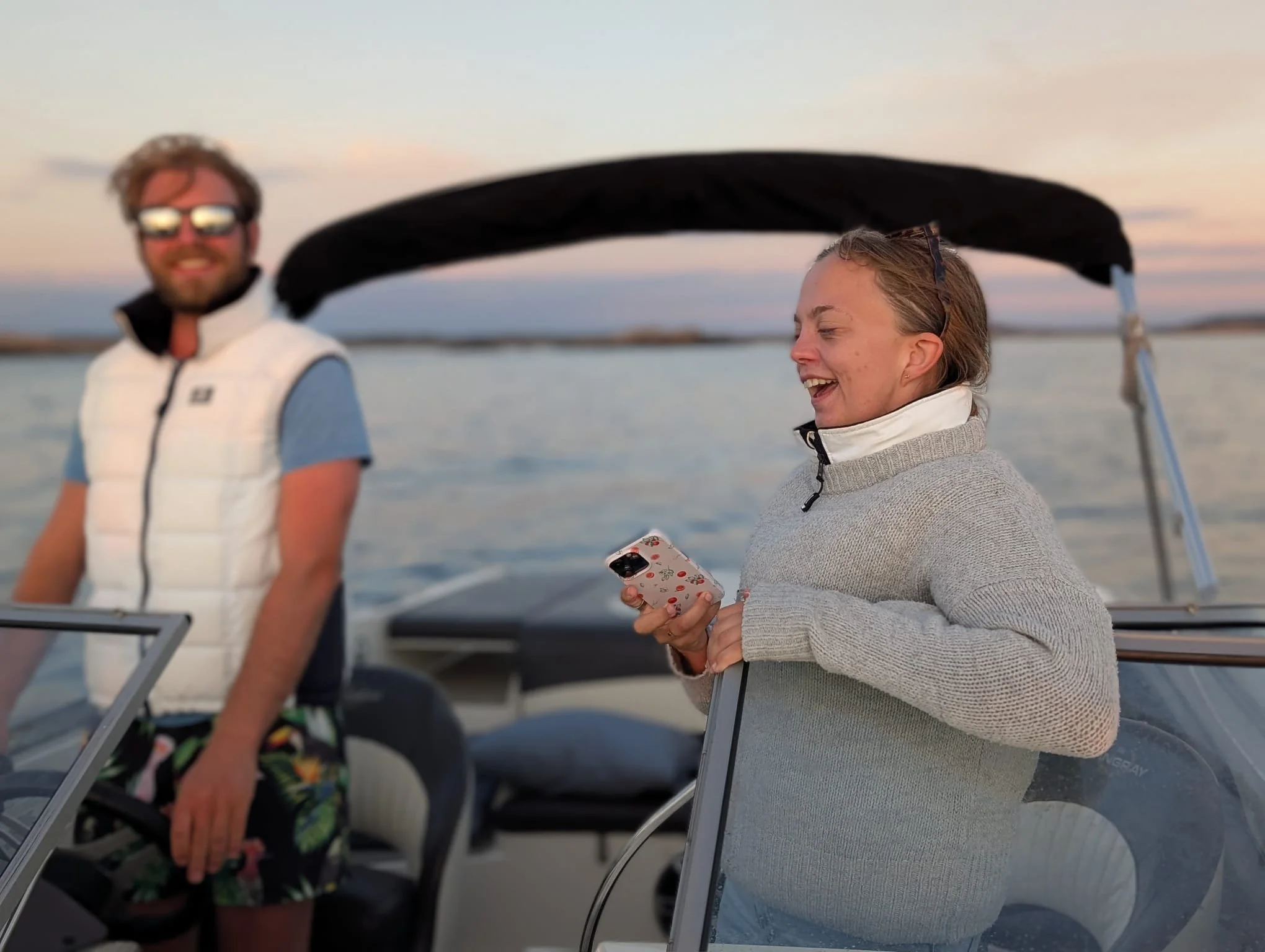 Couple enjoying private boat tour at sunset on Sweden’s west coast archipelago