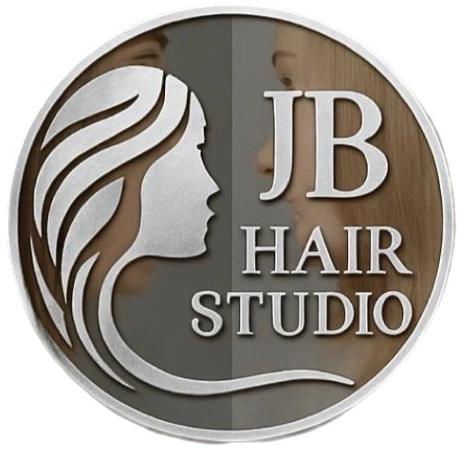 A circular sign for JB Hair Studio featuring a silhouette of a woman's face with flowing hair on the left and a close-up profile of a woman's face with styled hair on the right.