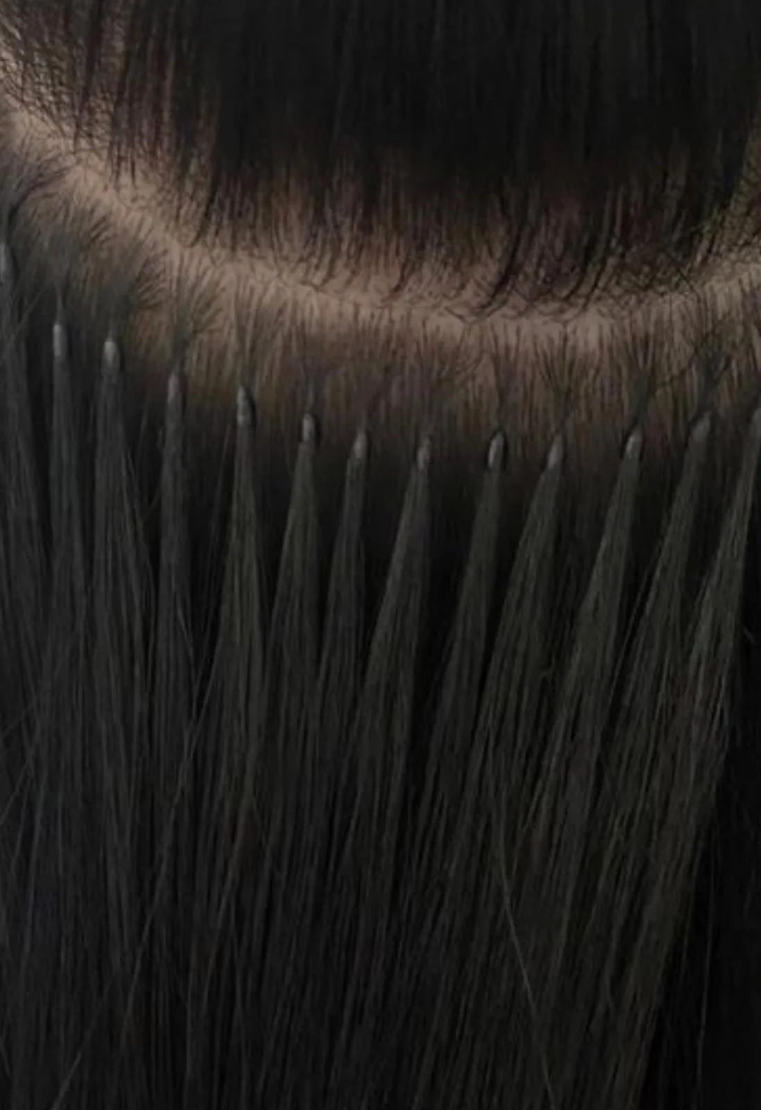 Close-up of a person's nose with dark facial hair, and black eyelash extensions or eyelashes.