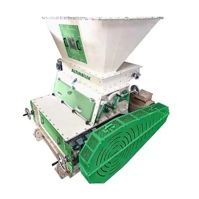 Agricultural seed cleaner machine with a green lower enclosure and a white hopper on top.