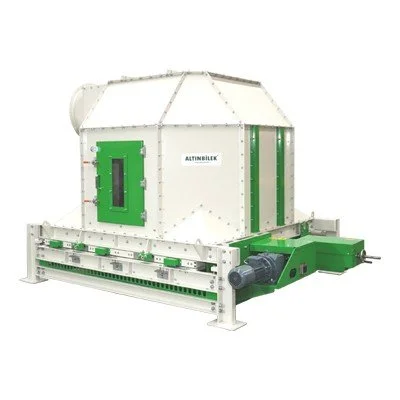 Industrial machine with a white and green color scheme, featuring a large box-shaped chamber and a conveyor belt at the front.