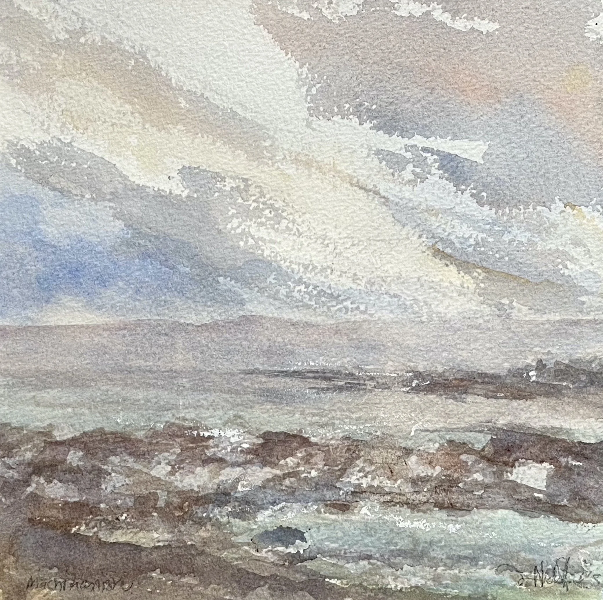 Watercolor landscape of a cloudy sky over a rocky shoreline with distant hills in the background.