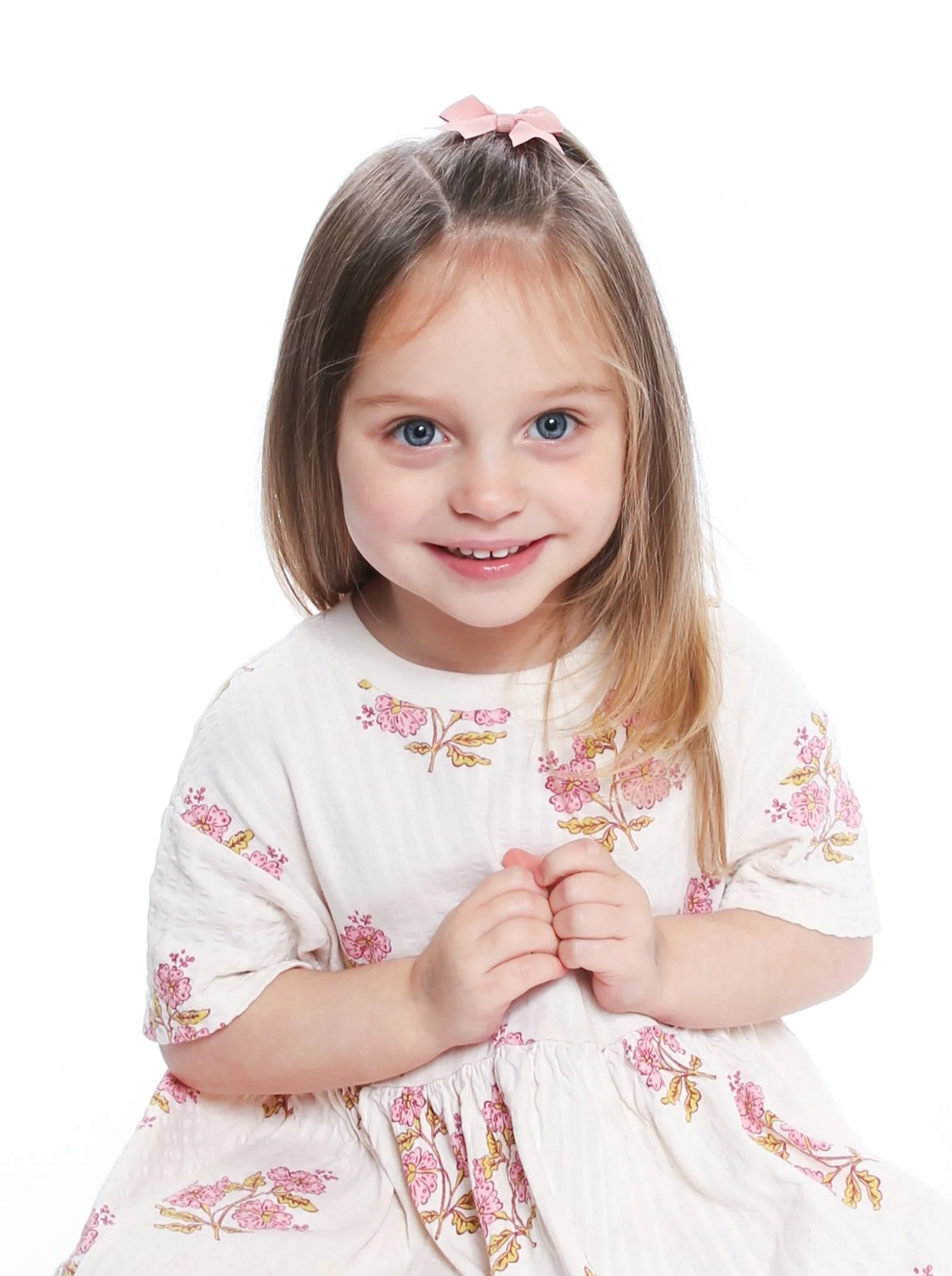 Young children smiling during a nursery portrait photography session in Manchester