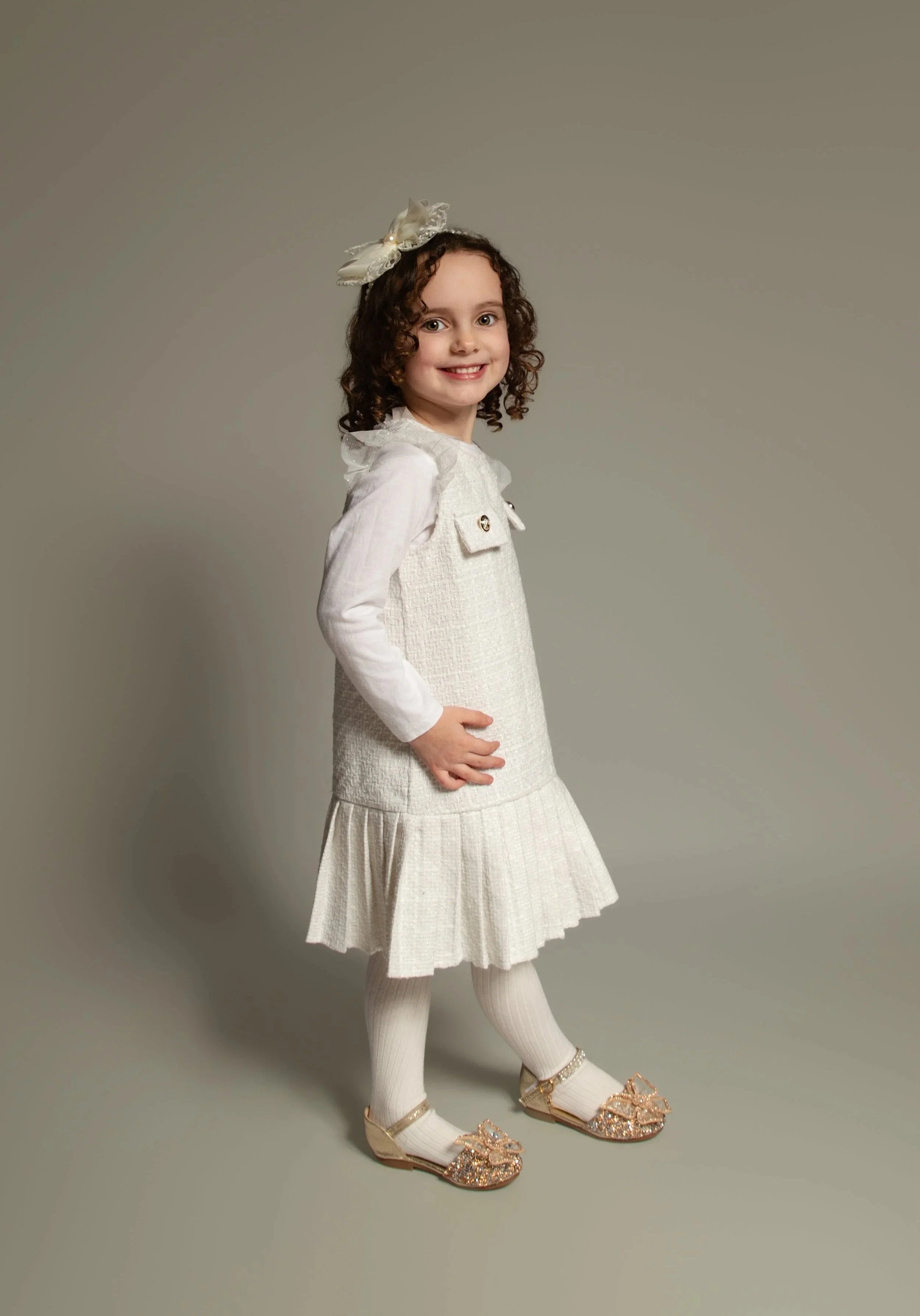 Young girl smiling in a white dress for her portrait photoshoot in whitefield manchester