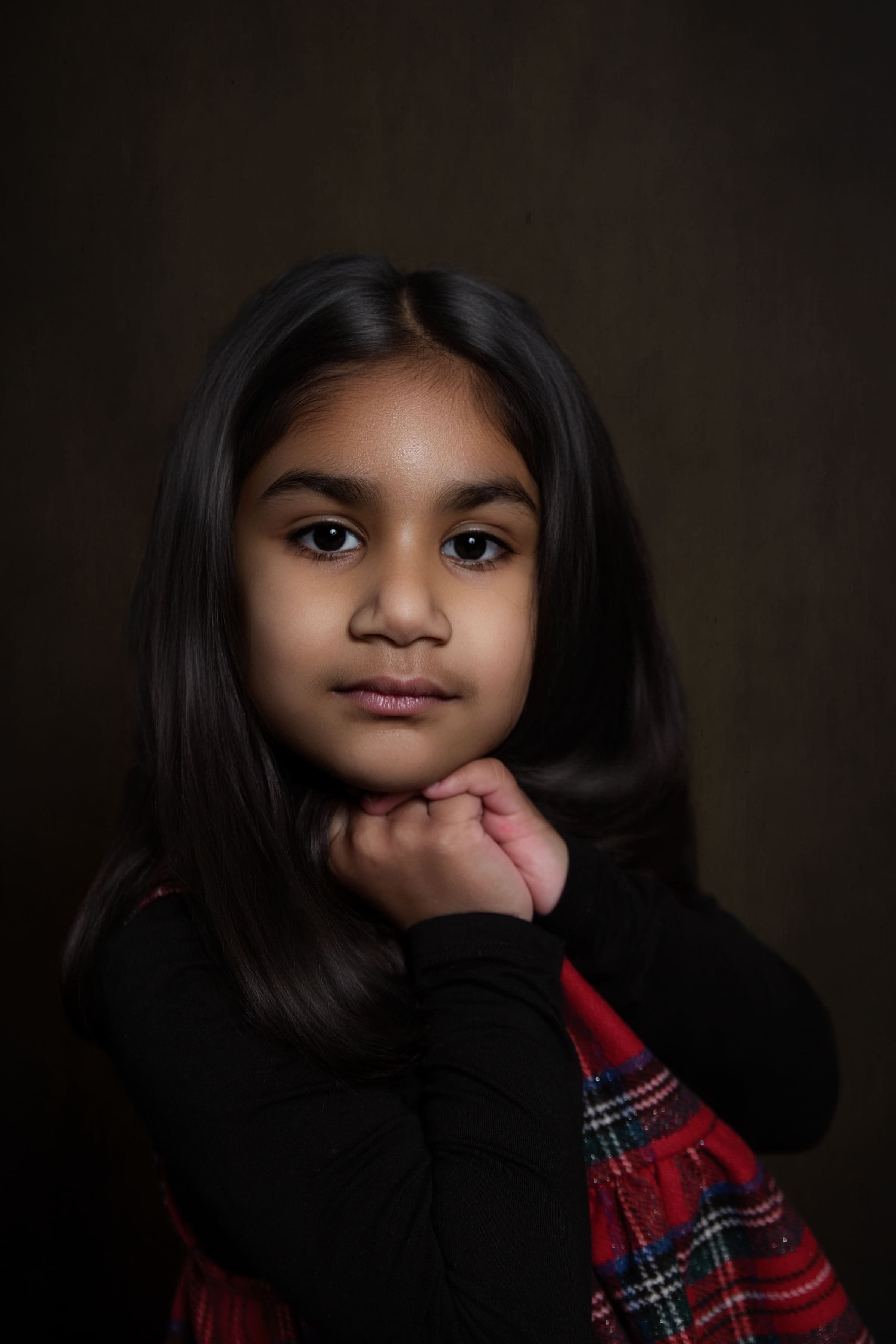 Studio style portrait of four year old boy on neutral background photographed in his home in Bury, Manchester