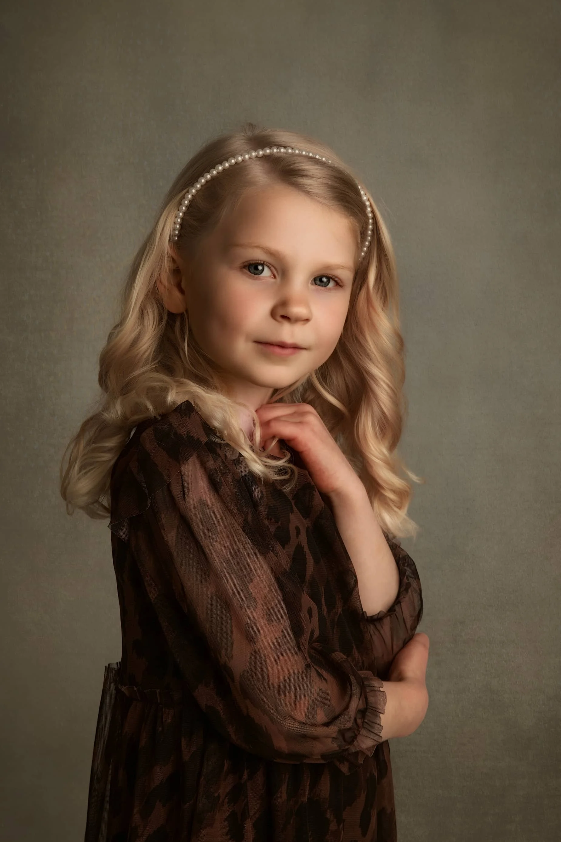 Fine art close-up portrait of young girl using soft studio lighting, creating a timeless and elegant children’s fine art portrait