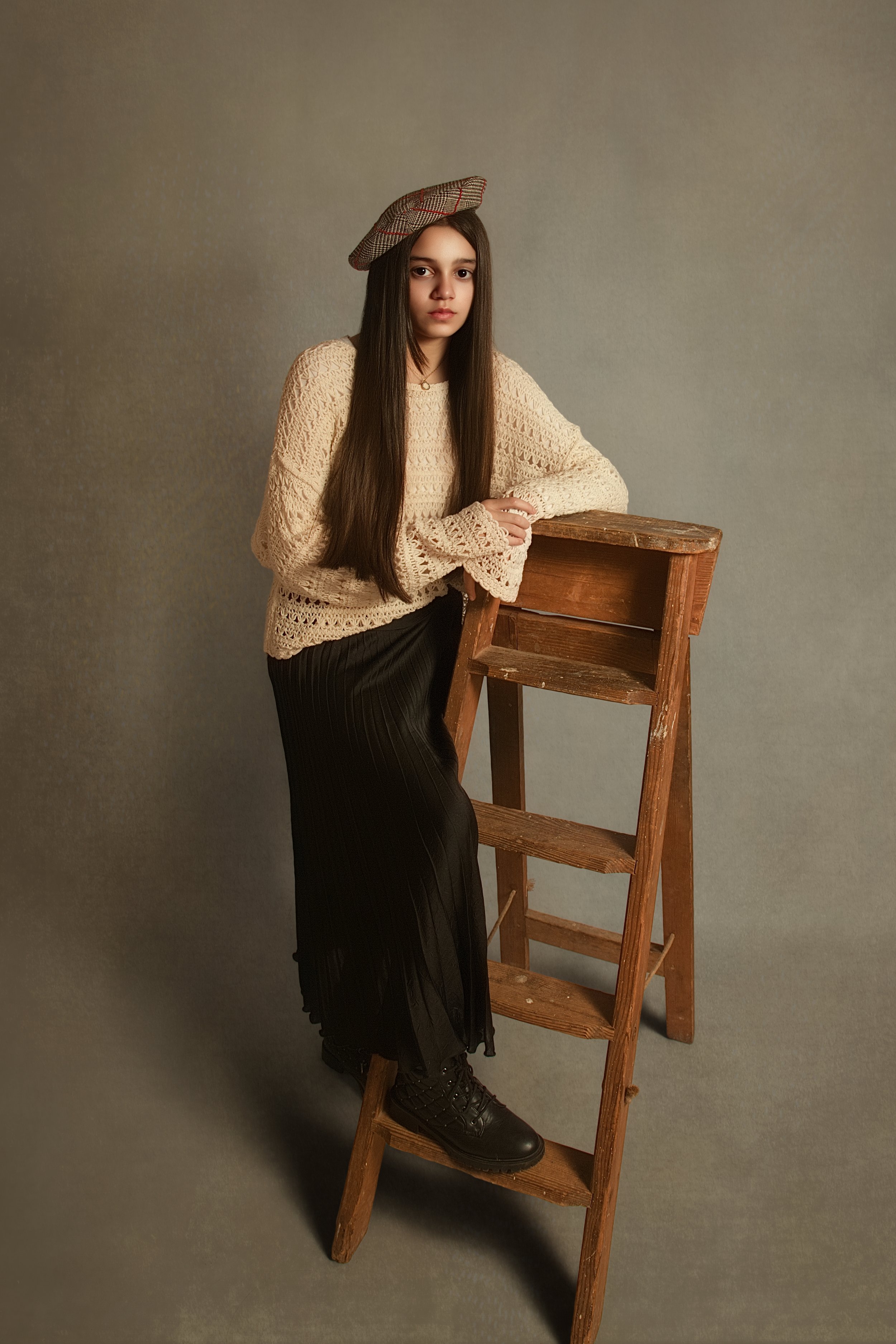 Fine art childrens portraiture photography. younf girl leaning on a wooden step ladder with long brown hair. Old masters style photgraph by Bury portrait photographer