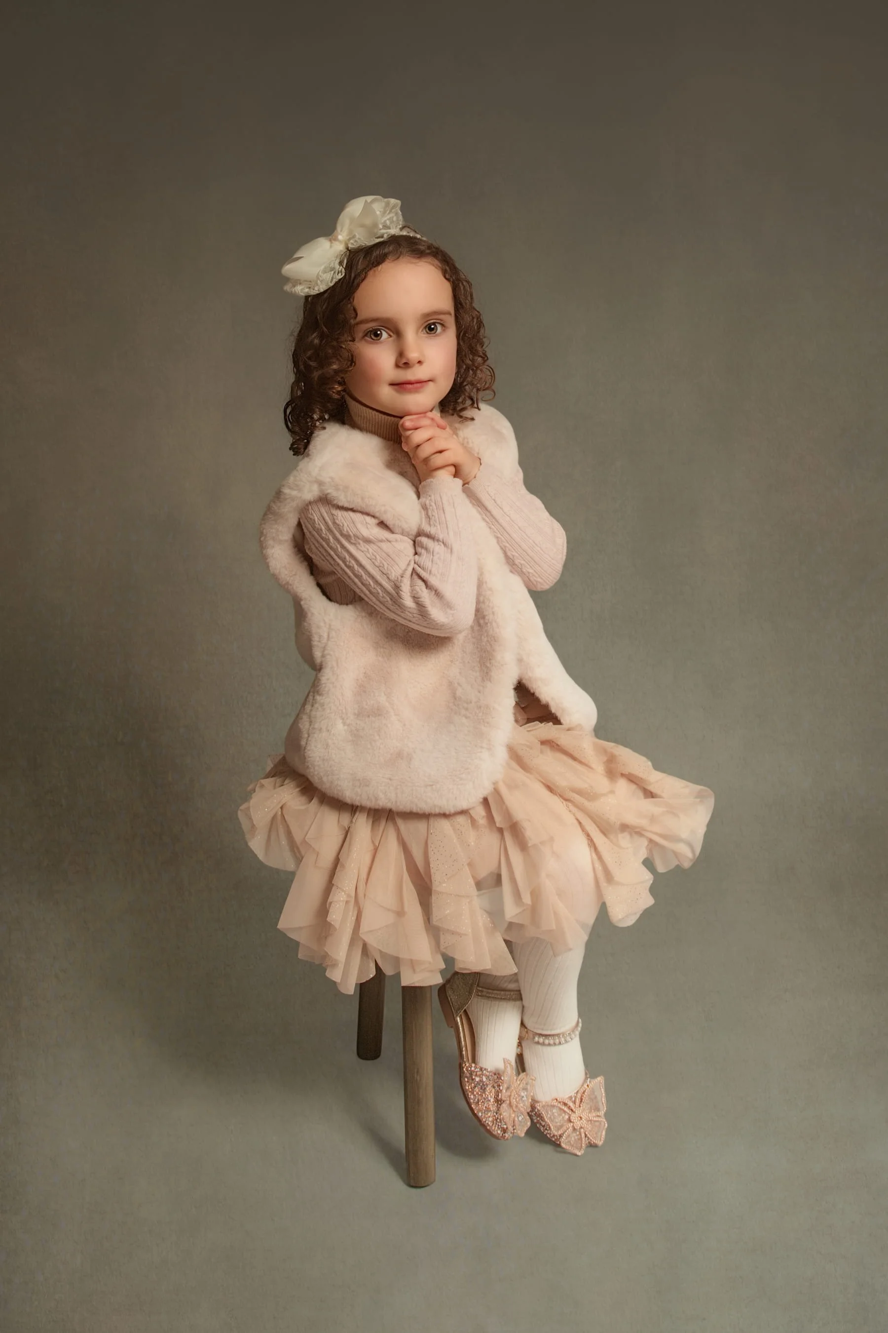 Fine art portrait of young girl sitting on stool, timeless children’s photography style in Greater Manchester.