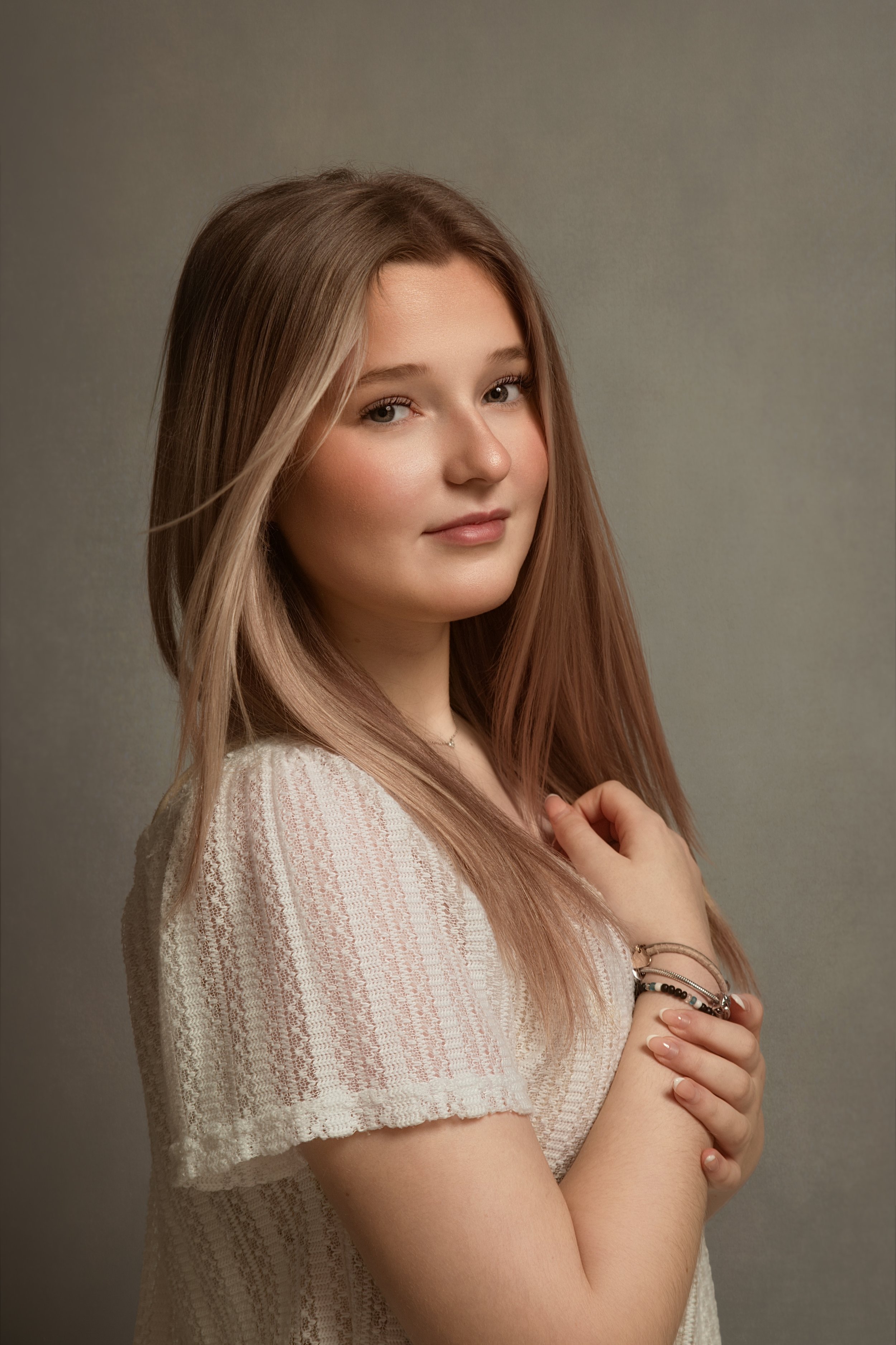 Fine art children’s portrait of a girl photographed in a studio session near Bury, Greater Manchester. A beautifully styled, minimalist portrait focusing on natural expression, soft tones, and refined detail for a truly timeless finish.